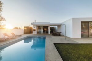Modern house with garden swimming pool and wooden deck